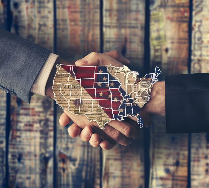 Conceptual image showing two hands shaking behind a map of the US