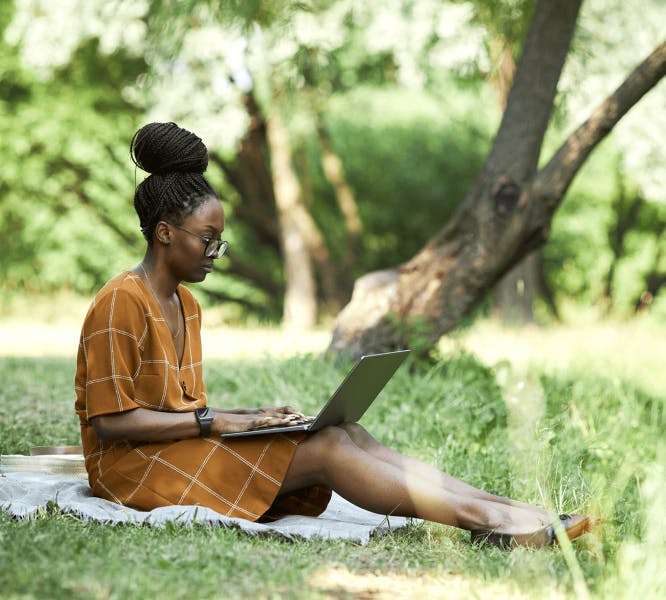 Woman working on laptop in the garden 