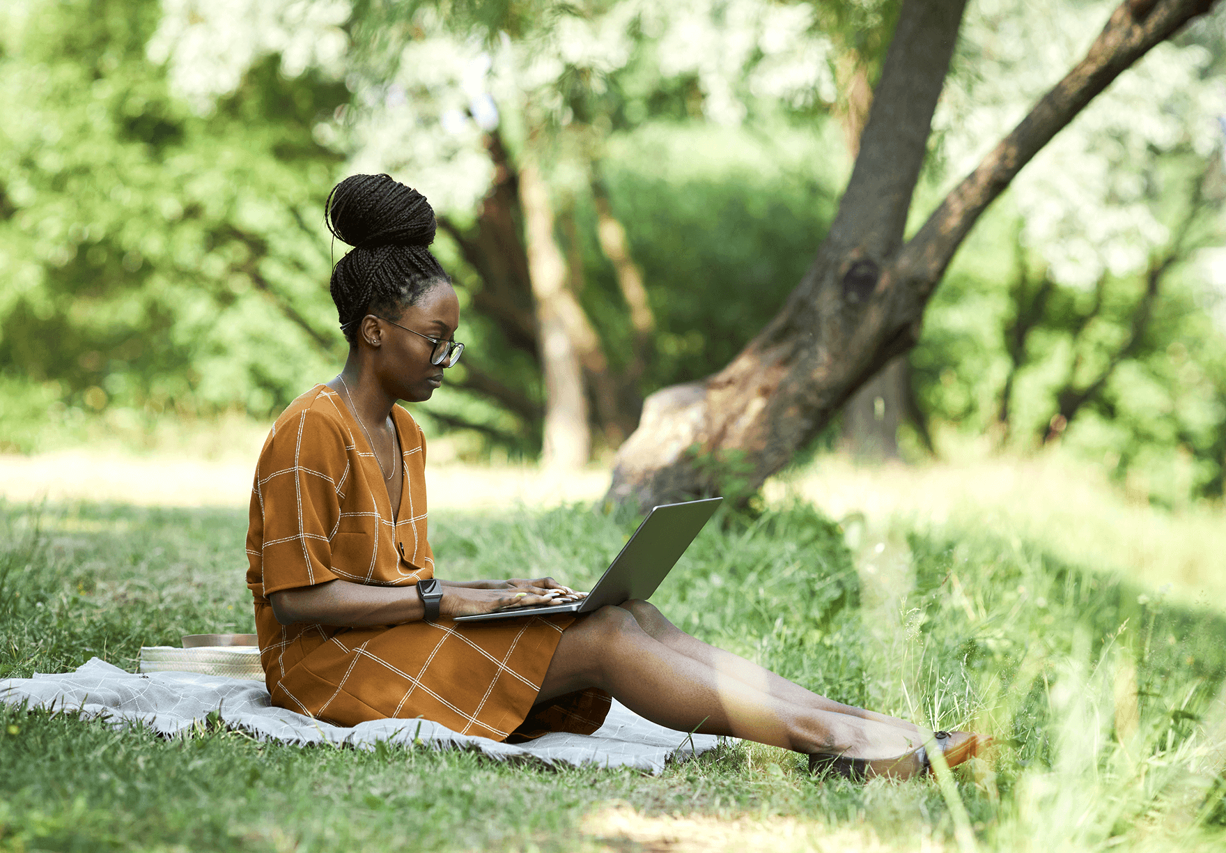 Woman working on laptop in the garden 