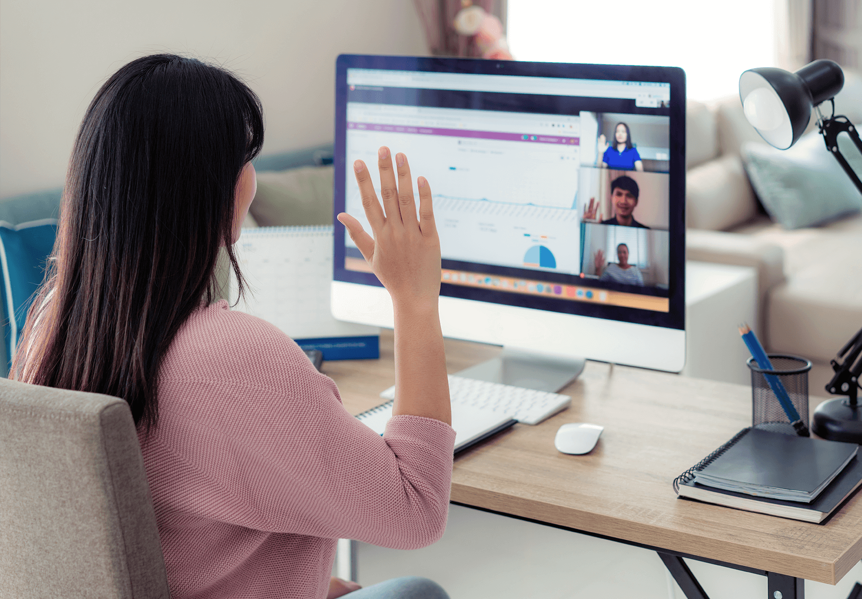 a woman greeting her remote engineers on a video call