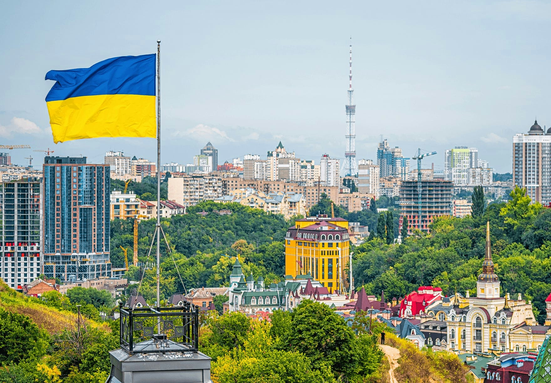 The flag of Ukraine waving above the city
